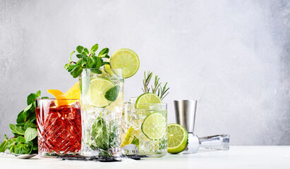 Most popular alcoholic cocktails set: mojito, gin tonic and negroni on gray background with bar...