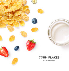 Creative layout made of corn flakes, strawberry, blueberry and milk on the white background.Flat lay. Food concept.