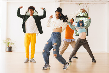 Fototapeta premium Image of diverse female and male hip hop dancers during training in dance club