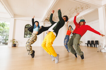 Image of group of group of diverse female and male hip hop dancers practicing in dance studio