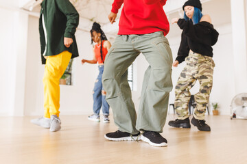 Image of low section of group of group of diverse female and male hip hop dancers in studio - Powered by Adobe