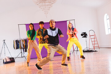 Image of group of group of diverse female and male hip hop dancers taking part in photo shot