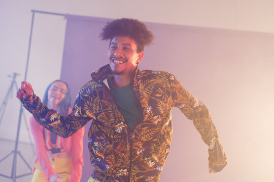 Image of happy diverse female and male hip hop dancers in studio