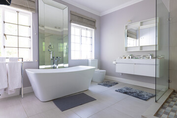Fototapeta na wymiar Free standing bath in luxury modern bathroom at home, with copy space