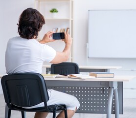 Young male student in front of whiteboard