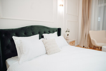 Fototapeta na wymiar Close up of beautiful green bed, elegant and comfortable modern bedroom. Interior design details