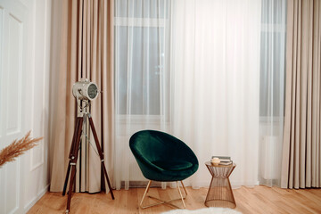 Stylish and modern loft design with modern furniture,, wooden coffee tables, plaid,, tropical plants and elegant personal accessories in stylish home decor. Neutral living room design