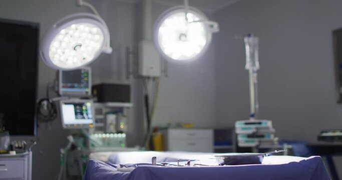 Video of illuminated lights and electronic medical equipment in operating theatre, with copy space