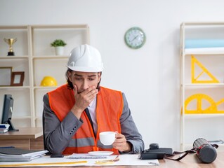 Young male architect working in the office