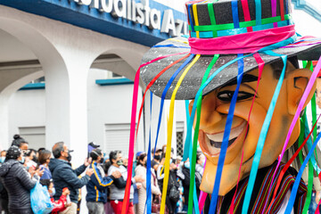 Carnival parade in the historic center of city Cuenca. Giant puppet as ecuadorian. Ecuador