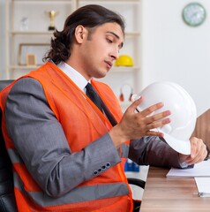 Young male architect working in the office