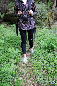Low section of woman walking on field in forest