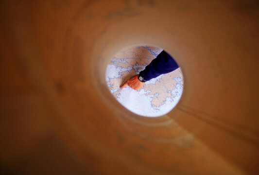 Close-up of hand pointing out kayaking areas off Eastern Newfoundland.