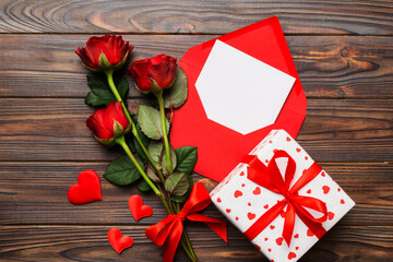 Valentine day composition with Envelope, rose flower and Red heart on table. Top view, flat lay. Holiday concept