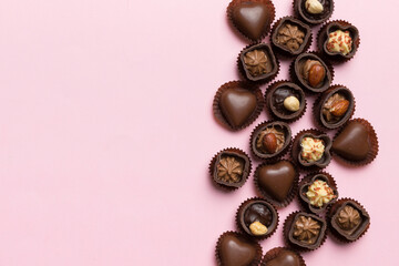 Different kinds of chocolates on colored table close-up. Top View and Flat Lay with copy space