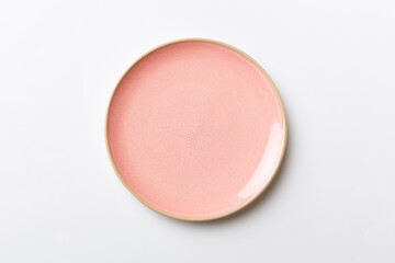 Top view of isolated of colored background empty round pink plate for food. Empty dish with space for your design