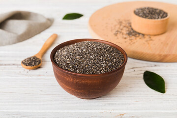 Chia seeds in bowl and spoon on colored background. Healthy Salvia hispanica in small bowl. Healthy superfood