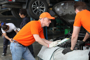 Fototapeta na wymiar car service, repair, maintenance and people concept - auto mechanic team