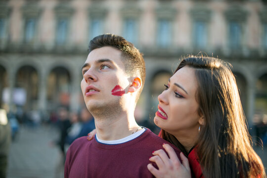Funny couple portrait, the man has a lipstick kiss mark on his cheek