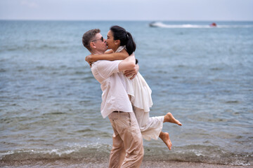 Love couple on holiday happy playing running along the beach and sweet kiss on love emotion