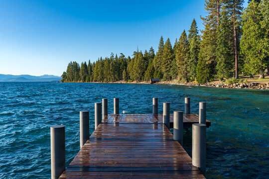 Sugar Pine Beach Park in South Lake Tahoe, California with Piers, Blue Lake, Sand, Water, Greenery and room for text.