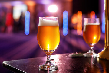 A glass of cold draft beer in a pub.