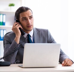 Young male accountant working in the office