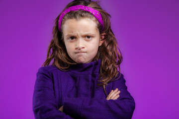 angry frustrated young girl with frown expression and arms crossed