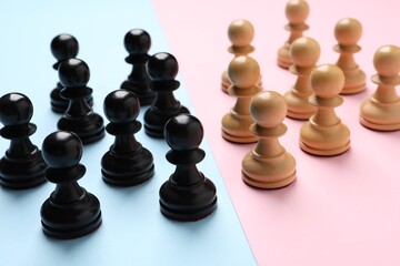 Chess pieces on color background, closeup. Gender equality