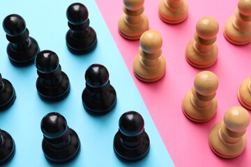 Chess pieces on color background, closeup. Gender equality