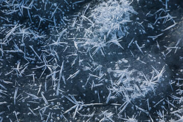 Hoarfrost crystals on icy surface, closeup view