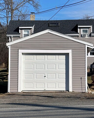 One CAR GARAGE as  a free structure with white painted door.