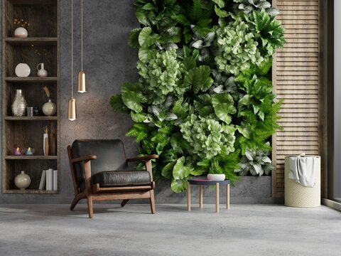 Green plant wall background with leather armchair on empty concrete wall.