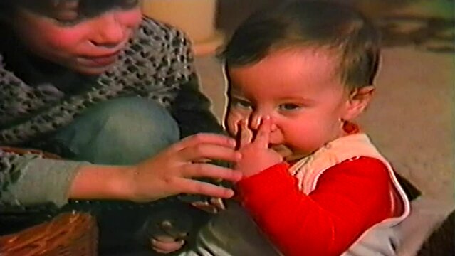 Two little brothers playing with toys,family retro home video