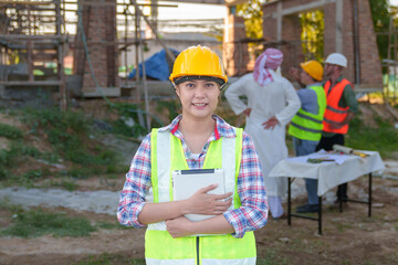 Diverse team of professionals using tablet computers on construction site. Real estate construction project. with civil engineers, architects, Arabic business investors and explorer with theodolite