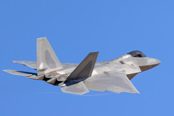 Fototapeta na wymiar Close tail view of a F-22 Raptor in beautiful light