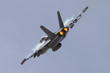 Very close tail view of a U.S. Navy EA-18G Growler in a high G maneuver, with afterburners on and...