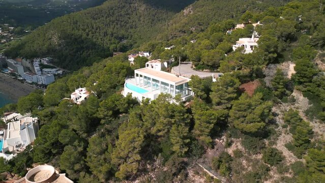 Luxury finca with pool. Calm aerial view flight panorama orbit drone
island ibiza villa Cala de Sant Vicent, autumn 2022. High Quality 4k Cinematic footage