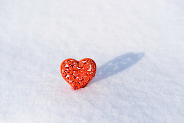 Valentine, Red heart in snow. Valentines day card, February 14 background. Red frozen heart on white snow. Velvet Valentine on snowy background