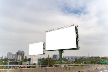 Fototapeta premium Mockup image of billboard beside highway. Large blank billboard pole beside highway in city at morning.