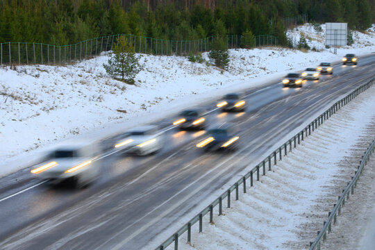 Cars at speed on motorway on a day of winter, in-camera motion blur.
