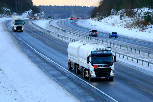 White Volvo FM fuel tanker for ADR 33-1203 gasoline transport in motorway traffic on a day of winter. 