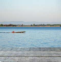 empty old wooden table  morning lake  fisherman driving a boat