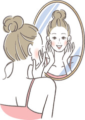 鏡を見て微笑む女性