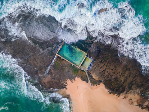 Tidal swimming pool built on a rock shelf surrounded by ocean