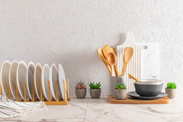 background kitchen utensils. front view of the dryer with plates, cutting boards, bowls and spoons....