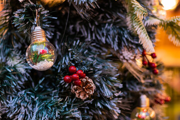 Close up of ball bauble hanging from Christmas tree.