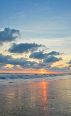 Sunset on a beach in Acapulco, Pie de la Cuesta beach, sun setting to the horizon in Mexico