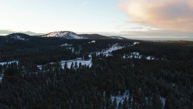Winter's Majestic Beauty: A Sunset View of Snowcapped Mountains and a Snowy Forest in British Columbia