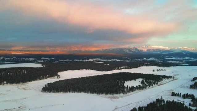 The Canadian Rocky Mountains in Winter: A Sunset Aerial View of a Snowy Forest